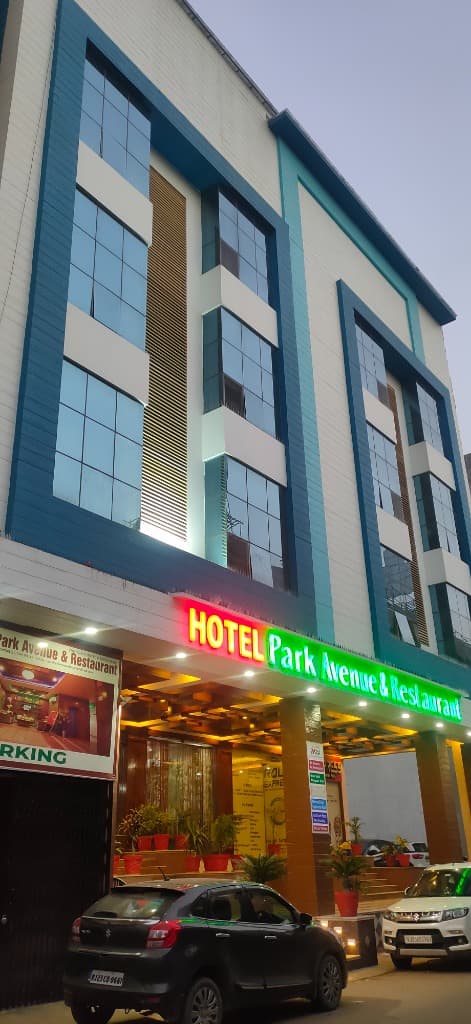 Hotel Park Avenue Sikar illuminated entrance at night with neon signboard
