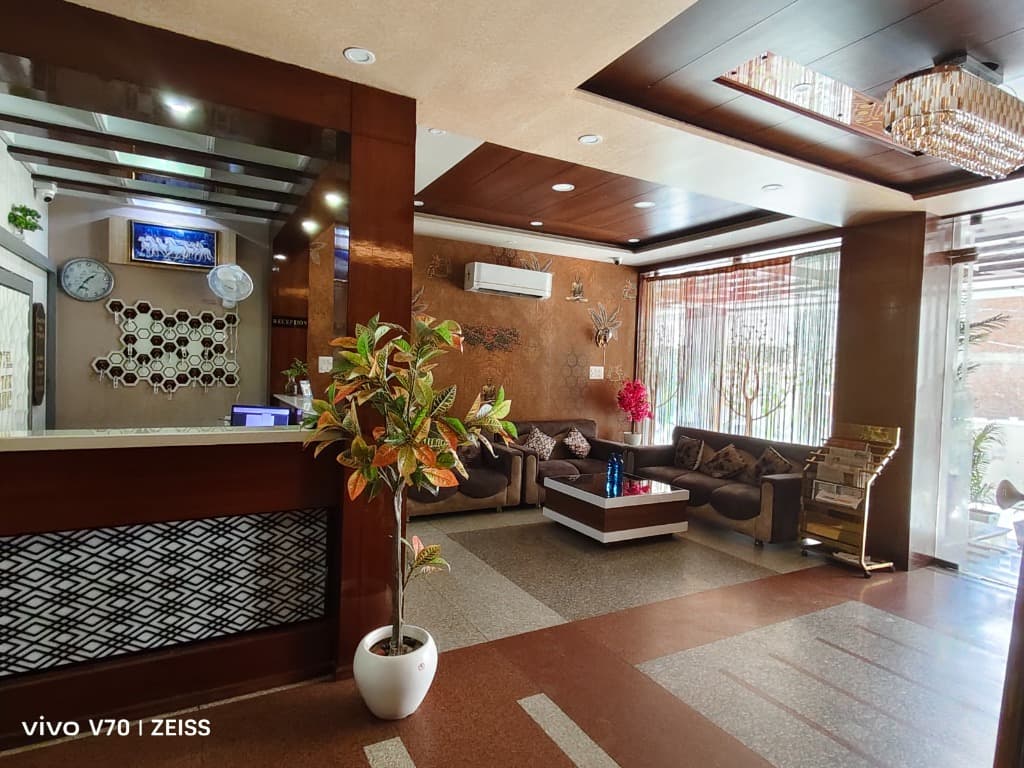Elegant guest lounge and wood finished reception desk at Hotel Park Avenue Sikar